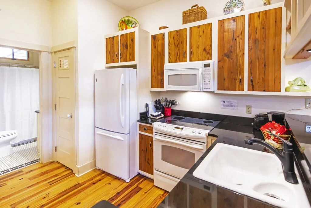 Flat 3 has a full kitchen including a dishwasher, oven, stovetop, microwave, and full size fridge.