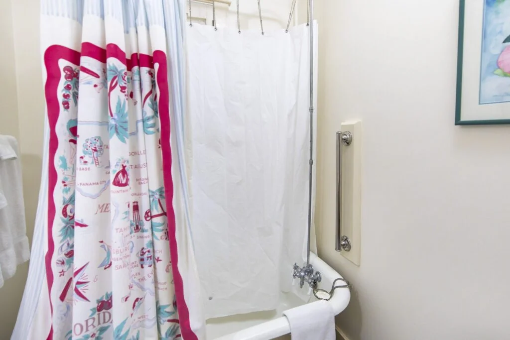 Another angle of the Hibiscus Rooms shower, this image shows the grab bar next to the tub